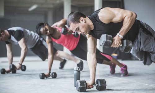 athletes-doing-push-ups-with-dumbbells-on-floor-royalty-free-image-1638463573